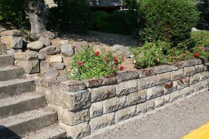 stacked stone retaining wall with planting area