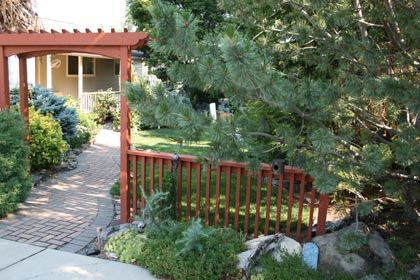 garden arbor and fencing with paver path
