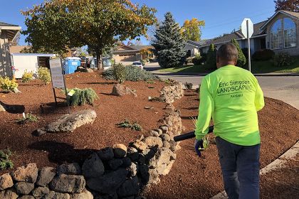 rock retaining wall and mulching installation