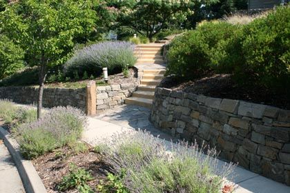 custom hardscaping stacked rock walls with cement stairs