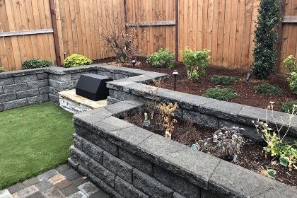 stone retaining walls, garden beds and fire pit