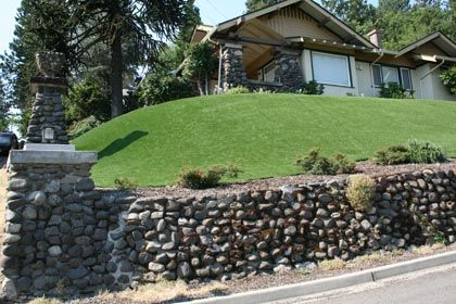 landscaping with artificial turf on hillside yard